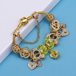 Golden charm bracelet with heart pendants and yellow crystal beads on snake chain