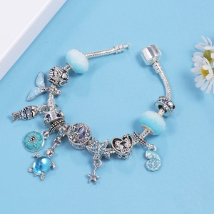Ocean-themed silver charm bracelet with blue crystal beads, sea turtle, starfish and mermaid tail