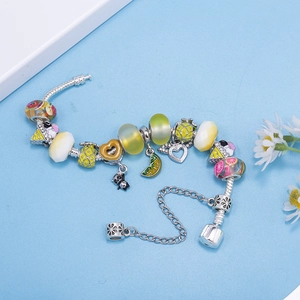 Silver-toned charm bracelet with colorful fruit pendants and panda charm on blue background