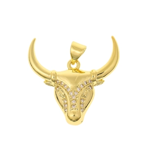 Macro shot of gold-plated bull head pendant with micro-inlaid cubic zirconia details