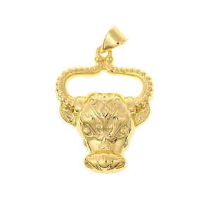 Detailed macro shot of a golden bull head pendant featuring intricate geometric engravings