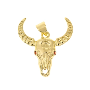 Macro shot of 18K gold-plated bull skull pendant with red zircon eyes and carved horns
