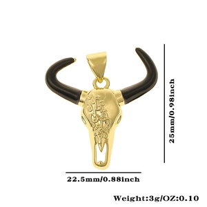 Detail view of gold bull skull pendant with zircon inlay and product size measurements