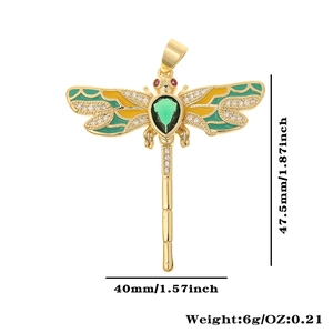 Detailed view of dragonfly pendant with green enamel wings and clear zircon accents