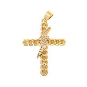Detailed shot of a gold cross pendant with Cuban chain texture and lightning bolt crystal