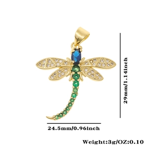 Macro view of gold dragonfly pendant with blue stone and sparkling zircon wings