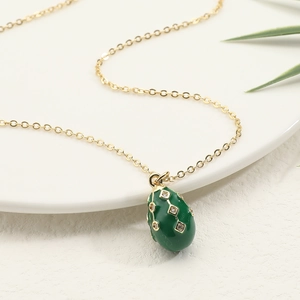 Green enamel egg pendant necklace in 18K gold plated copper with sparkling zircon accents