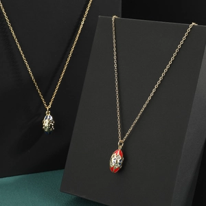 Elegant gold chain necklace featuring a red enamel oval pendant with micro-inlaid zircon