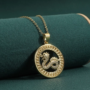 Collar colgante de dragón dorado con circonitas blancas en soporte de terciopelo verde