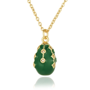Detail of vintage green enamel egg pendant with gold lattice and zircon inlay