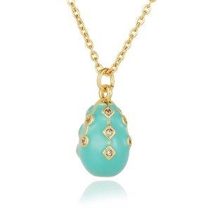 Macro shot of turquoise enamel egg pendant with crystals on 18K gold plated necklace