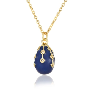 Macro detail of Fabergé style blue egg pendant with 18K gold plating and zircon inlay