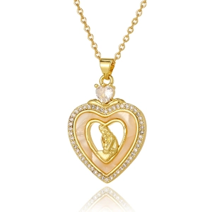 Detailed macro of golden heart pendant with Virgin Mary relief and zircon inlay