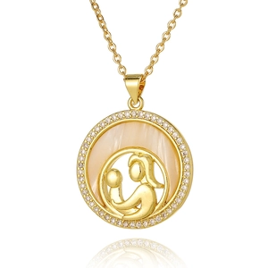 Detail of gold mother and child silhouette pendant with mother of pearl and crystals