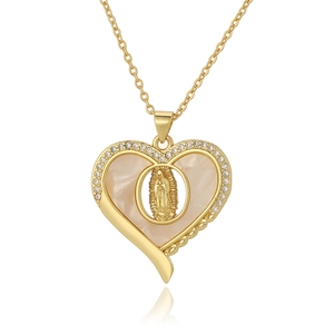 Detail of gold heart pendant with Virgin Mary relief and sparkling zircon inlay