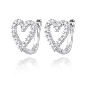 Detailed view of silver heart earrings with micro-paved cubic zirconia stones and mirror reflection