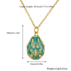 Detail of teal enamel egg pendant with gold filigree showing 28x15mm dimensions and 45cm chain