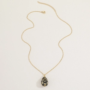Detail of Russian egg pendant necklace with black enamel and gold floral patterns