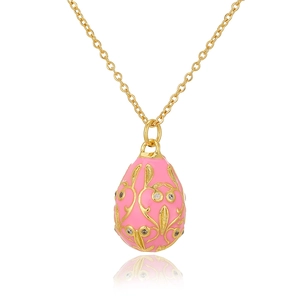 Macro detail of Russian egg pendant with pink enamel and gold filigree on a fine chain