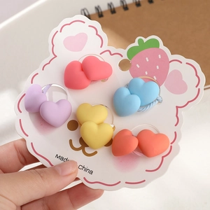 Detailed view of 5 pairs of colorful matte heart-shaped elastic hair ties for girls