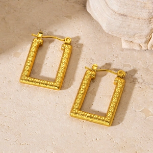 Detail of gold rectangular leverback earrings with Greek key pattern on stone