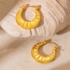 Detailed view of gold crescent hoop earrings with vertical pleated metal texture