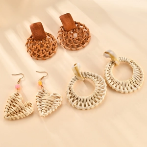 Three pairs of handmade raffia flower earrings featuring bohemian style for beach vacations
