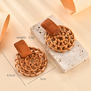 Detail view of woven raffia flower earrings showing 6.5cm length and 5.4g weight