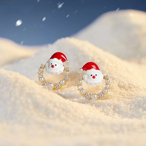 Macro view of Christmas Santa Claus wreath earrings with pearls and crystals
