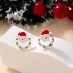 Macro detail of Santa Claus stud earrings with faux pearls and sparkling rhinestones