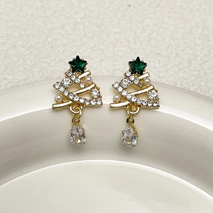 Detail of Christmas tree earrings with gold plating, rhinestones, and pearl accents