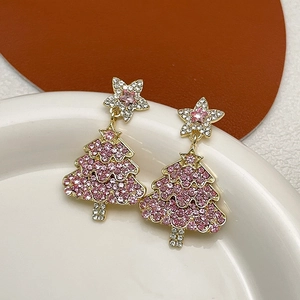 Pink rhinestone Christmas tree drop earrings with gold stars in a minimalist setting