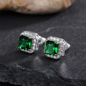 Macro detail of square emerald green zircon studs with silver micro-pave setting