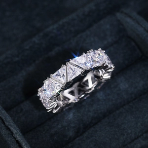 Macro shot of silver ring with continuous row of triangular-cut sparkling zircons