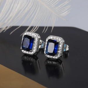 Detailed view of square blue zircon earrings with halo micro-pave setting and reflections