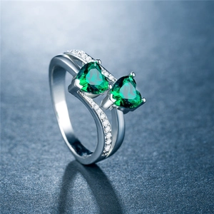 Makroaufnahme Doppelherz-Ring mit grünen Zirkonia und funkelndem Pavé-Besatz