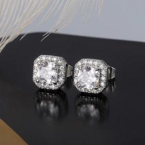 Macro view of square halo stud earrings with clear zircon and silver claw setting