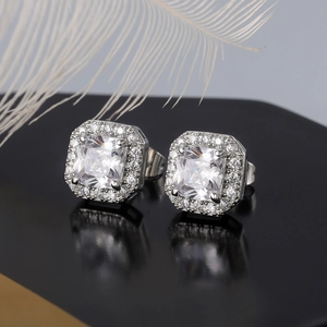 Detail view of square halo stud earrings with large central zircon and silver plating