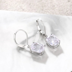 Detail view of cushion-cut blue topaz earrings with secure four-prong leverback setting