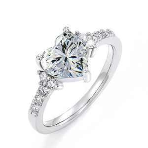 Elegant silver heart-shaped purple diamond ring featuring a classic claw setting and side accents
