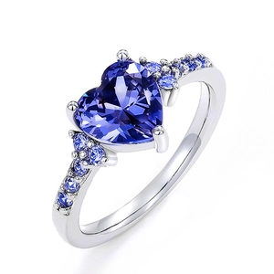 Elegant heart-shaped purple crystal ring with small side stones on a polished silver band