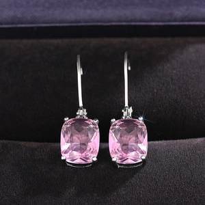 Pink cushion-cut stone earrings with silver hooks on black velvet jewelry case