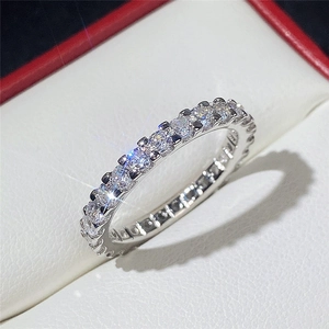 Macro shot of silver eternity ring with full circle round-cut sparkling diamonds