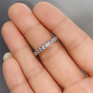Macro detail of silver eternity band with sparkling round cubic zirconia stones