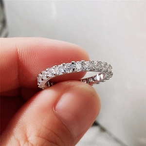 Classic silver geometric ring with row of zircon stones in a prong setting