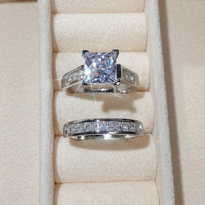 Macro shot of princess cut square zircon ring set in a beige velvet jewelry box