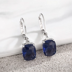 Detail of cushion-cut blue faux topaz drop earrings with secure leverback closures