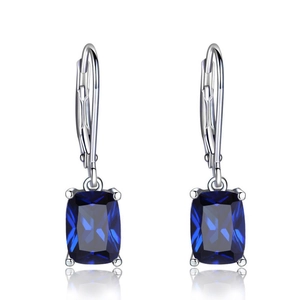 Close-up of lever-back earrings with rectangular blue cushion-cut cubic zirconia stones