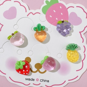 Detailed view of six resin fruit charms including strawberry and peach for DIY crafts