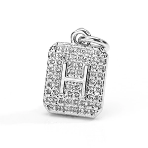Macro view of silver square pendant with micro-pave cubic zirconia and H letter